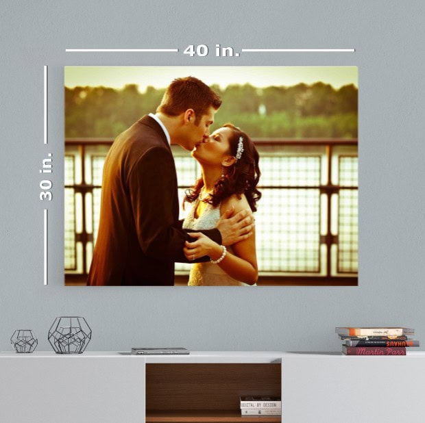 Wedding couple embracing on a balcony at sunset with scenic background.