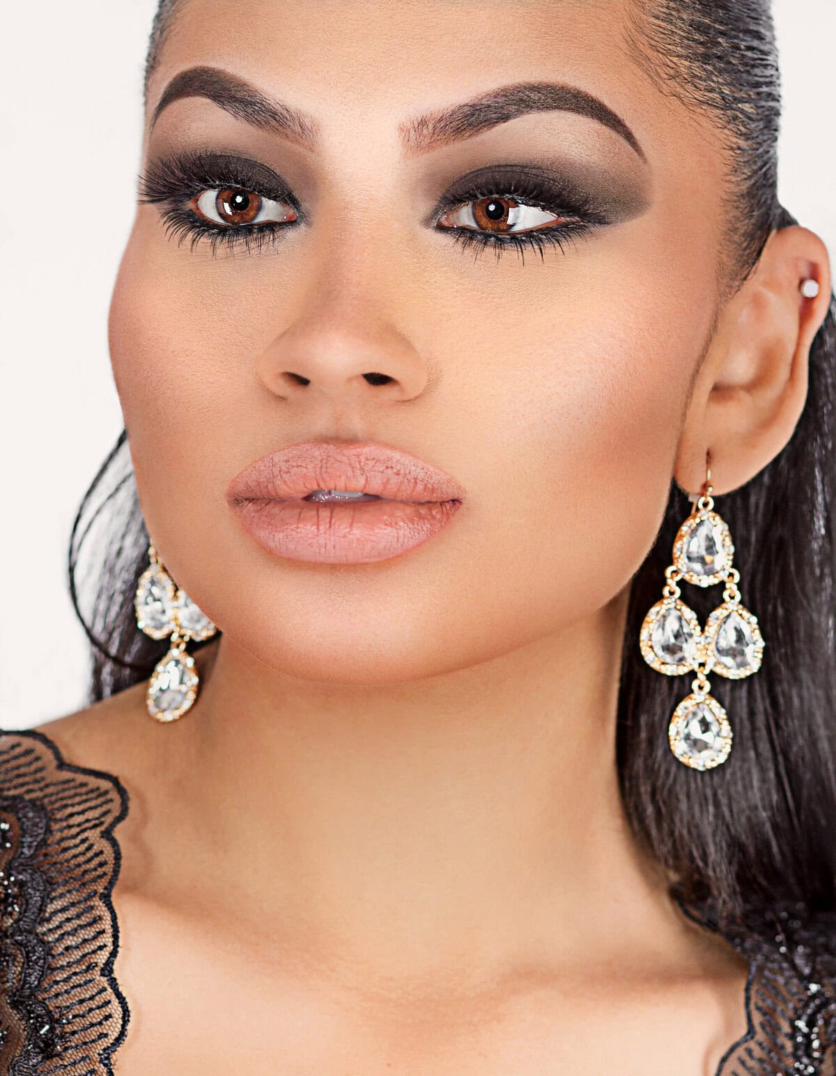 Glamorous Woman with Jewelry Close-up of a woman with makeup and jewelry, looking to the side.