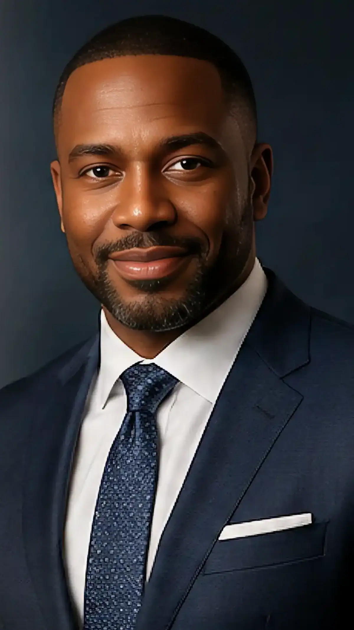 Professional portrait of a confident African American businessman in a suit.