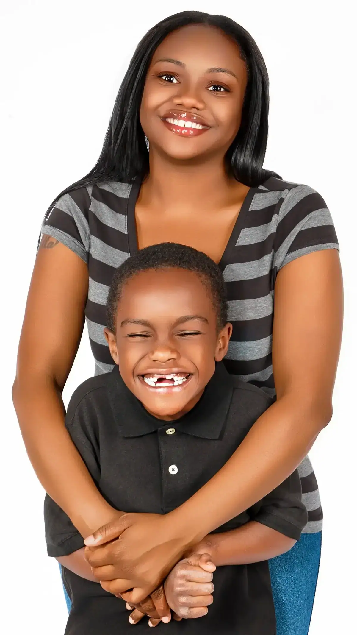 Happy mother and son smiling together in a studio setting.